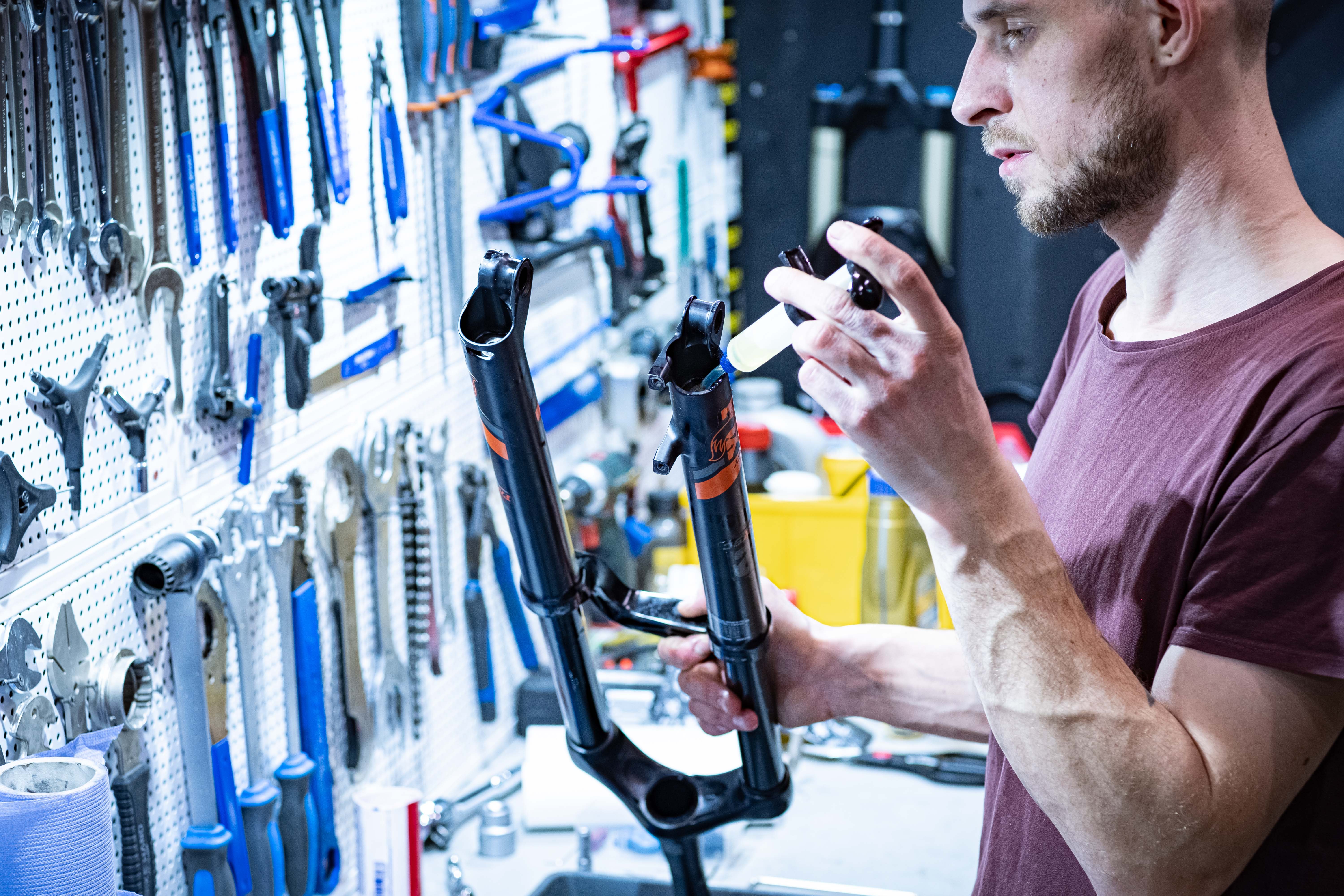 Man working on a tool rack in a garage